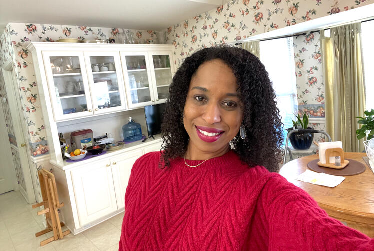 Jennifer Jackson, founder of Pages N’ Pans, smiling in a cozy kitchen — inviting home cooking enthusiasts into her story and community.